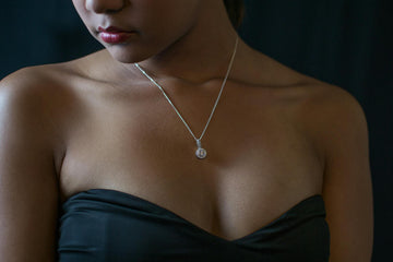 a woman wearing a Franc Laurent moissanite pendant necklace