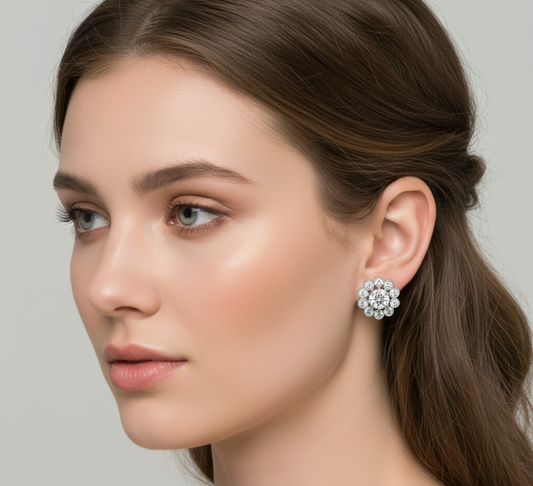 Close-up of a woman wearing a floral earring with a neutral background