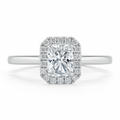 moissanite ring with a cushion-cut center stone and diamond halo on a white background